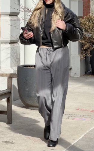 puffy black bomber jacket and a black turtleneck