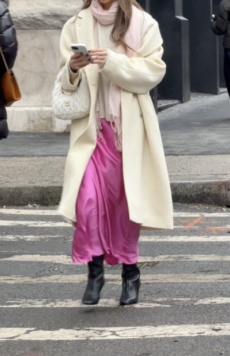  trench coat, turtleneck sweater, and croissant-shaped bag