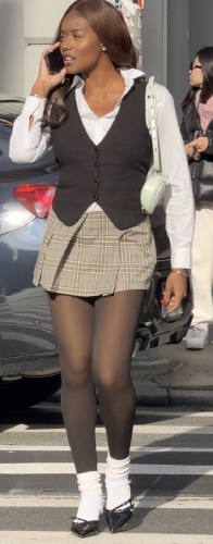 black vest over a crisp white collared long-sleeve shirt