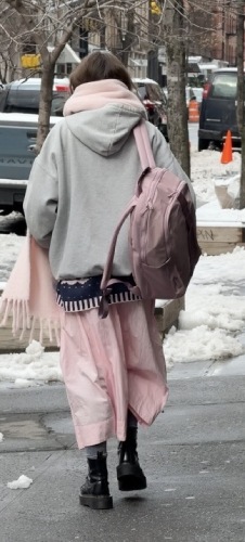 a soft knit scarf, a pink structured backpack, and a matching skirt